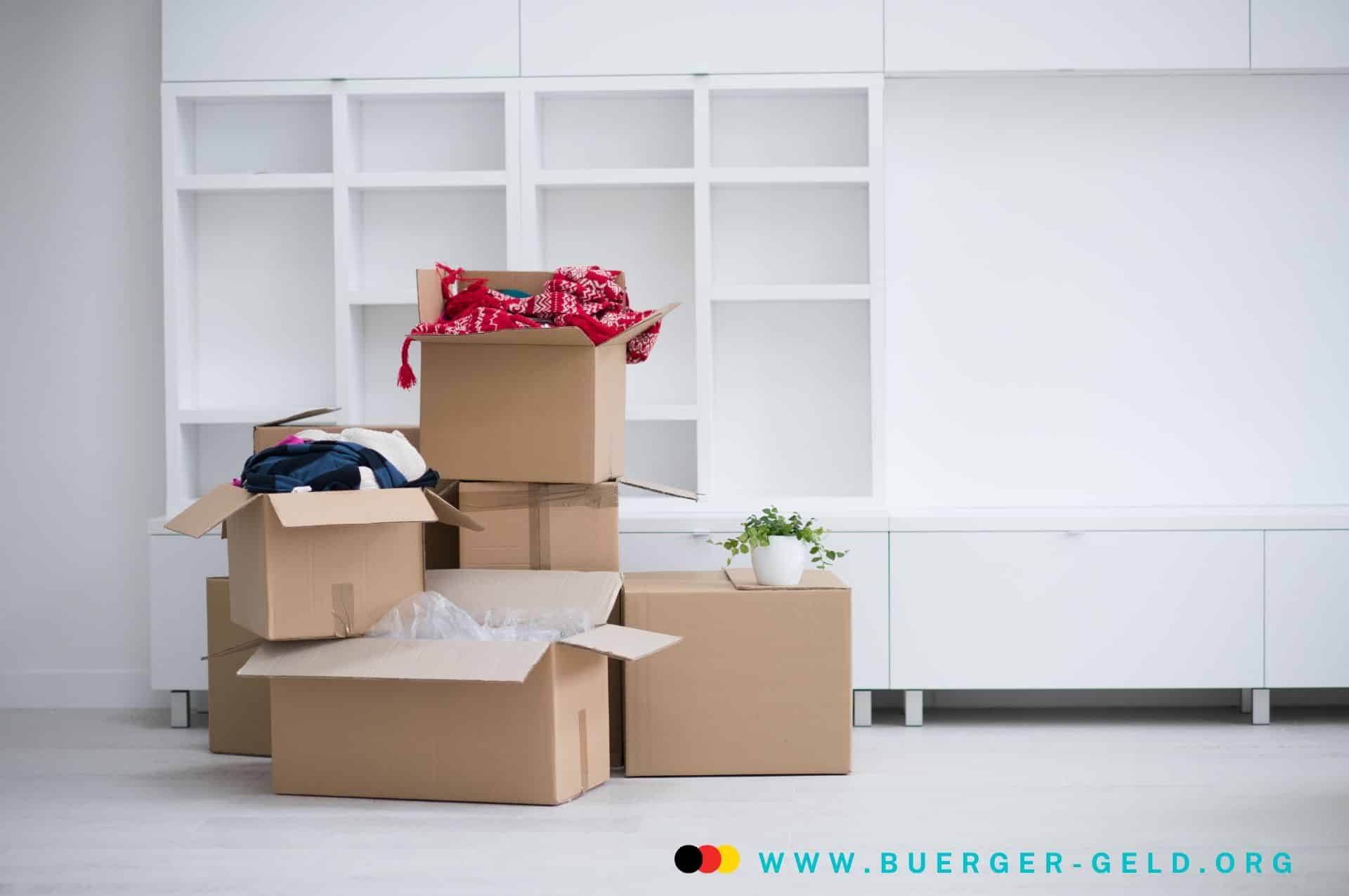 Umzugskisten stapeln sich in leerem Raum