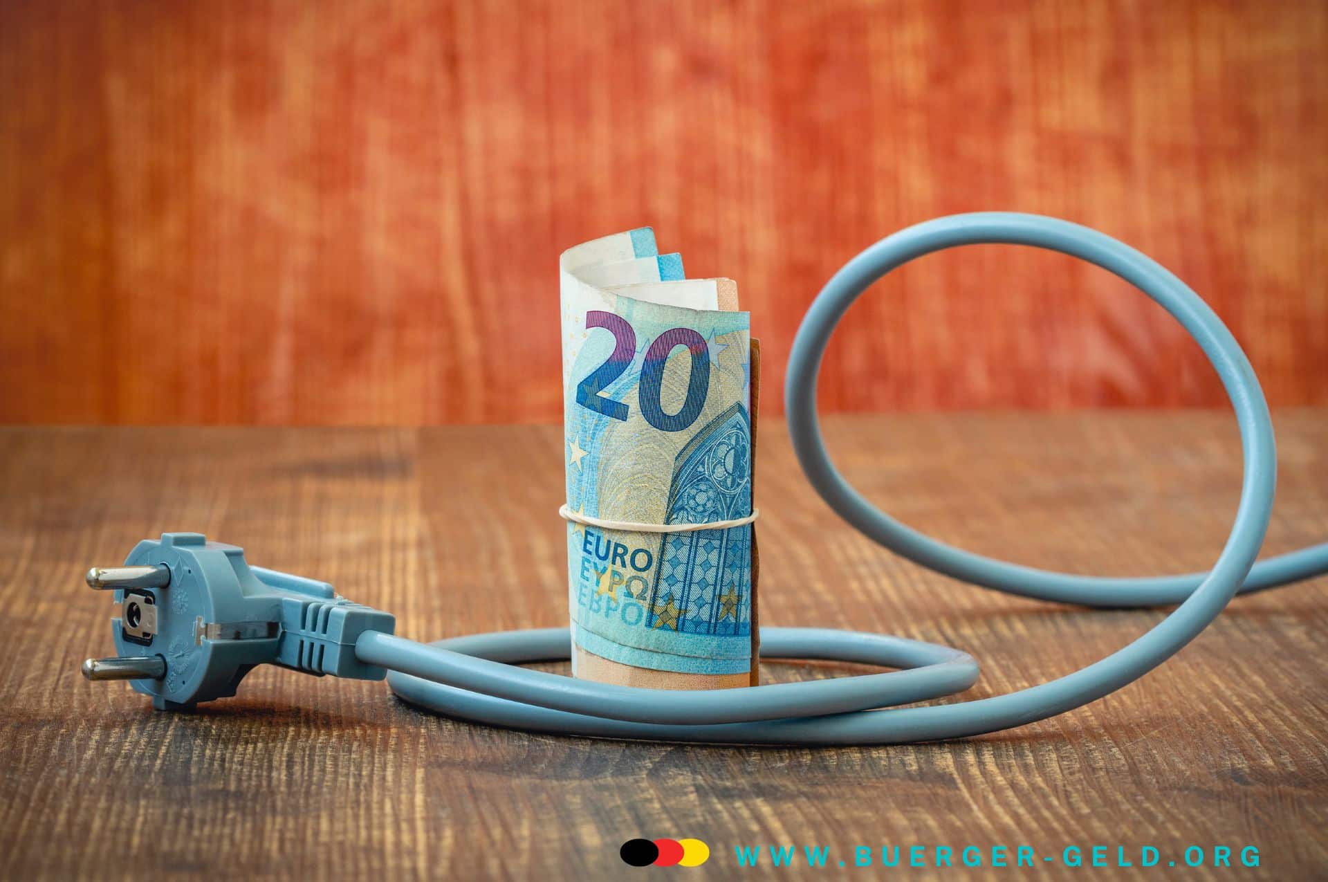 stromkosten 2025 aus buergergeld regelsatz herausnehmen 20 Euro Schein von Elektrokabel mit Stecker umwickelt