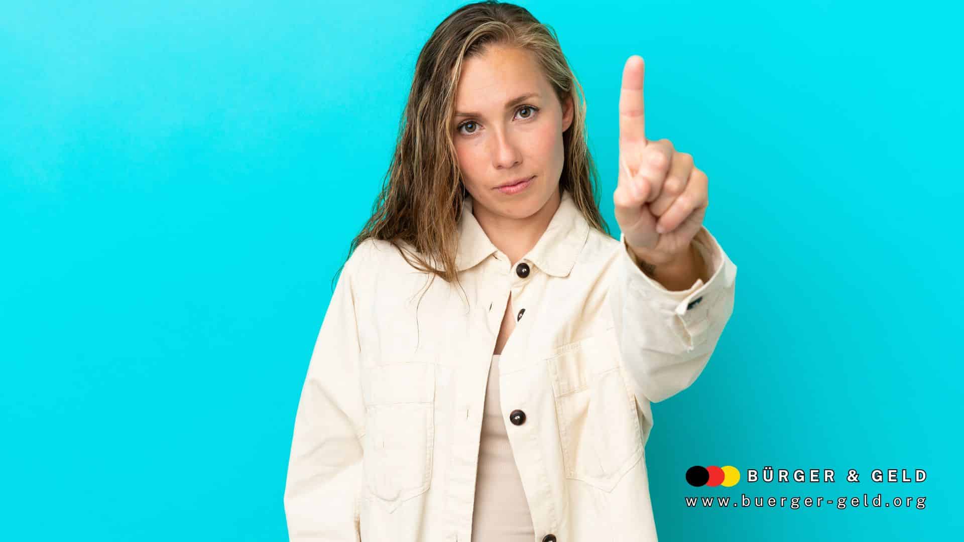 Junge Frau hebt mahnend den Zeigefinger