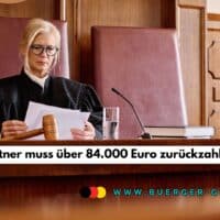 Richterin im Gerichtssaal sitzt an einem großen Holztisch, trägt eine schwarze Robe und liest Gerichtsunterlagen; auf dem Tisch liegen ein Richterhammer, ein Glas Wasser und ein Mikrofon.