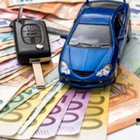 Miniaturauto und Autoschlüssel auf Euro-Banknoten – Symbol für Kfz-Steuerersparnis bei Schwerbehinderung auf Bürger & Geld Nachrichtenmagazin.