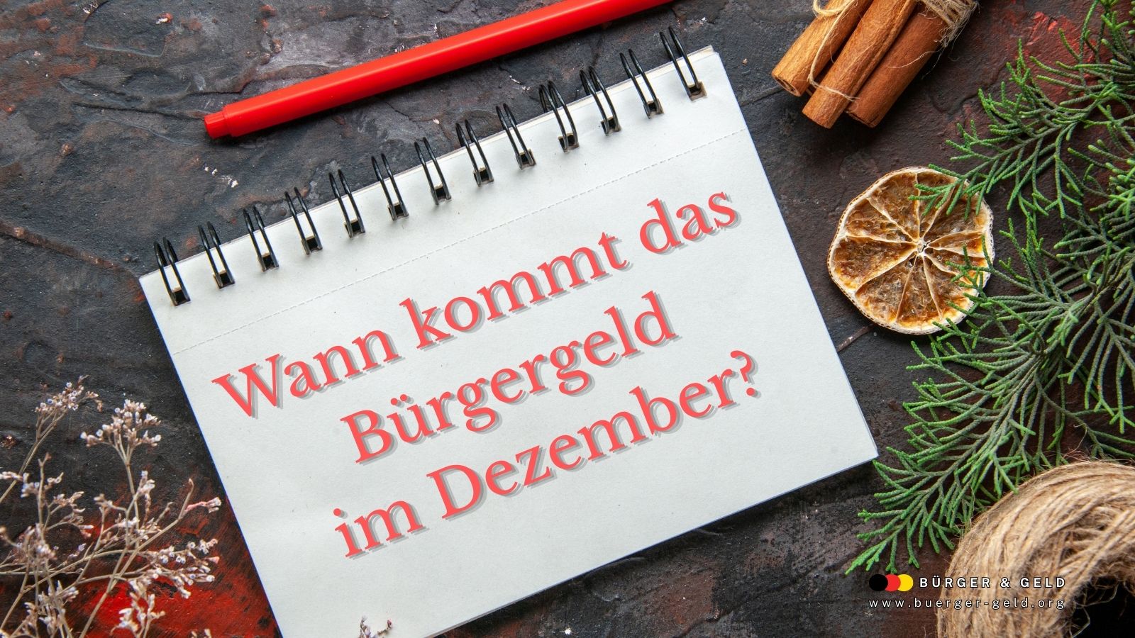 Notizbuch mit der Aufschrift „Wann kommt das Bürgergeld im Dezember?“; winterliche Deko mit Zimt, Trockenfrucht und Tannenzweigen; Logo „Bürger & Geld“ links unten.
